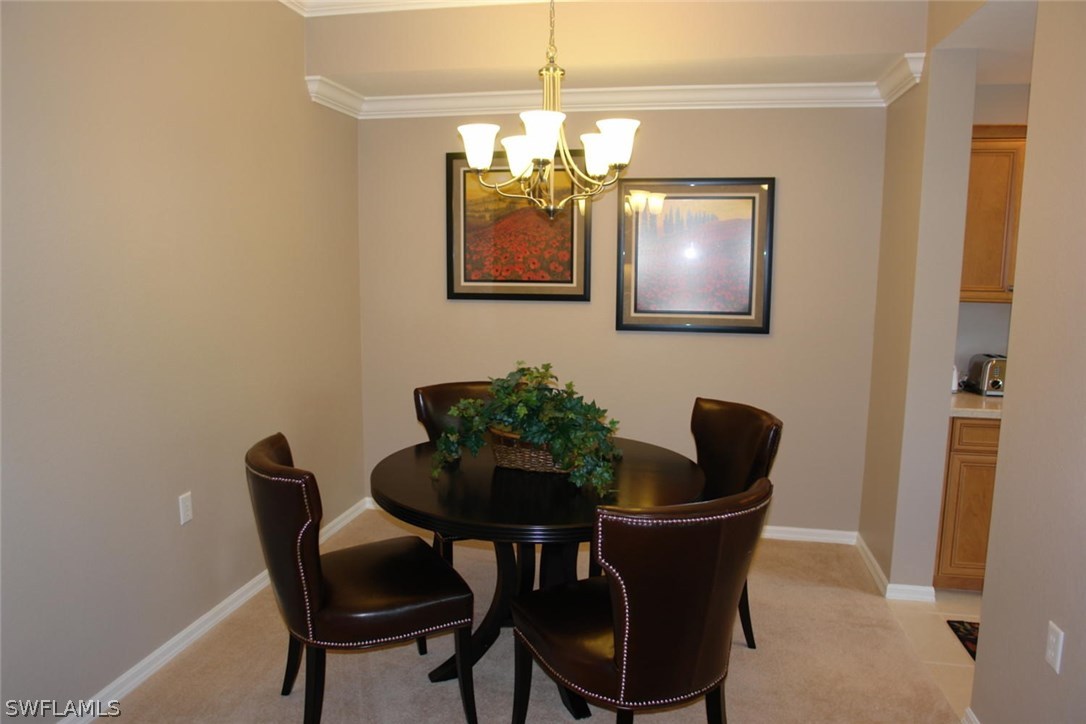 8251 Pathfinder Loop, Unit 624 Fort Myers, FL 33919 - Photo 7 of 15 a dining room with furniture and chandelier