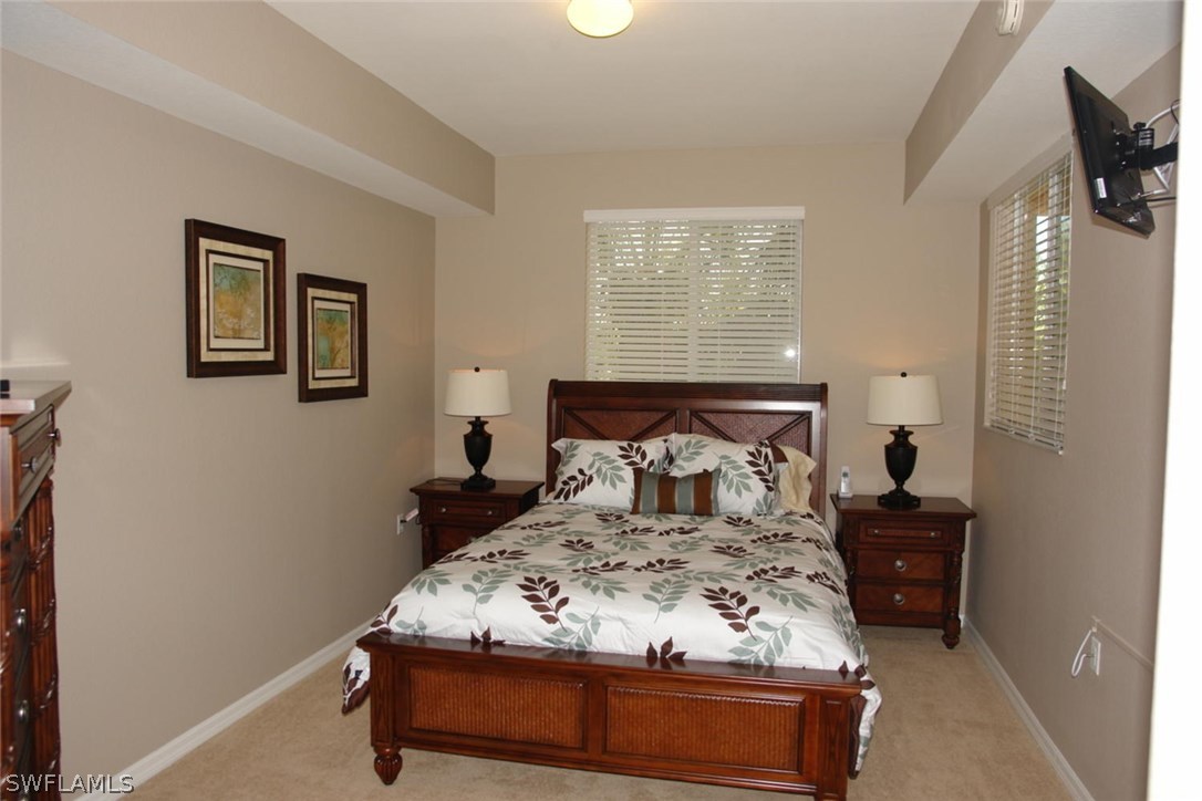 8251 Pathfinder Loop, Unit 624 Fort Myers, FL 33919 - Photo 8 of 15 a bedroom with a bed and a window