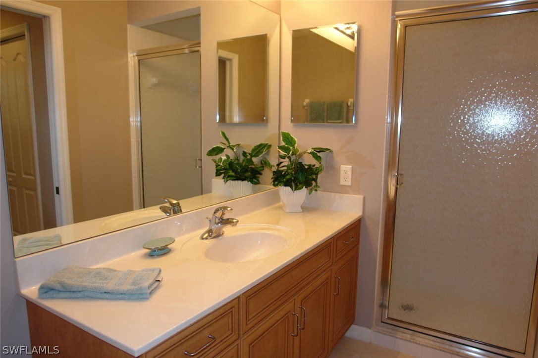 8251 Pathfinder Loop, Unit 624 Fort Myers, FL 33919 - Photo 9 of 15 a bathroom with a sink and a mirror