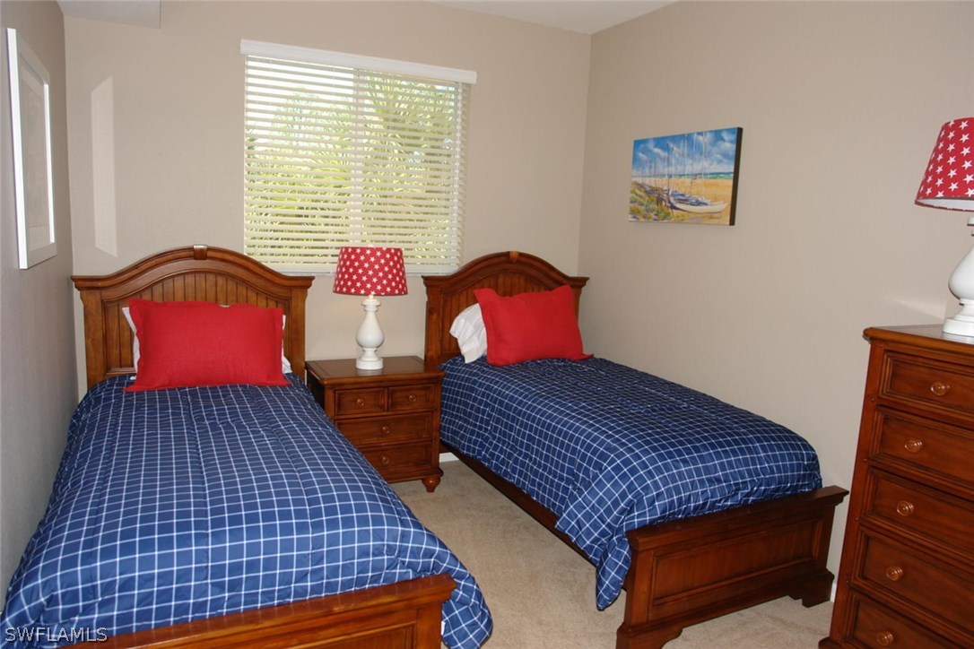 8251 Pathfinder Loop, Unit 624 Fort Myers, FL 33919 - Photo 10 of 15 a bedroom with two beds and a window