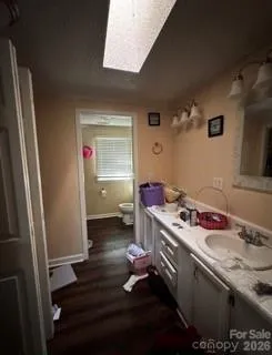 a room with a wooden floor and cabinets