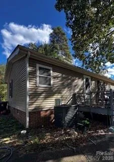 a view of house with wooden floor and a forest