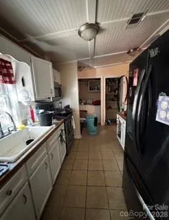 a kitchen with stainless steel appliances granite countertop a refrigerator a stove and a sink