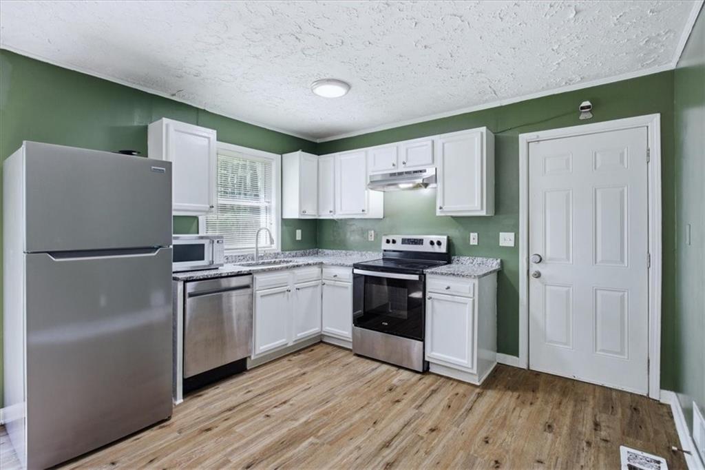 2536 Butner Road Atlanta, GA 30331 - Photo 6 of 42 a kitchen with granite countertop a refrigerator stove top oven and sink