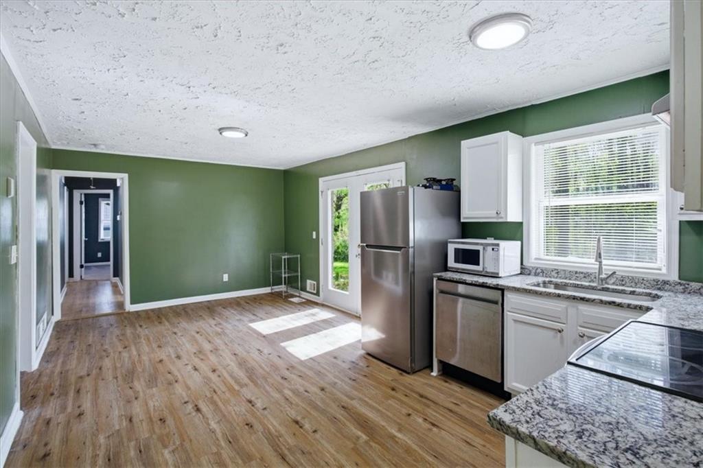 2536 Butner Road Atlanta, GA 30331 - Photo 7 of 42 a kitchen with stainless steel appliances granite countertop a refrigerator a sink dishwasher a stove with cabinets and wooden floor
