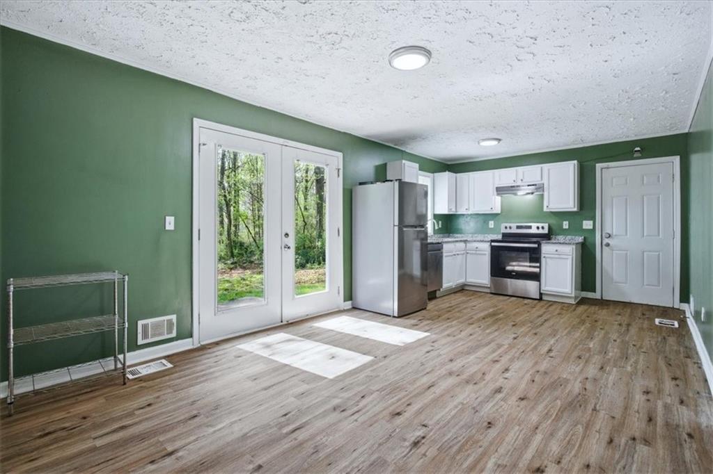 2536 Butner Road Atlanta, GA 30331 - Photo 9 of 42 a view of a kitchen with wooden floor electronic appliances and furniture