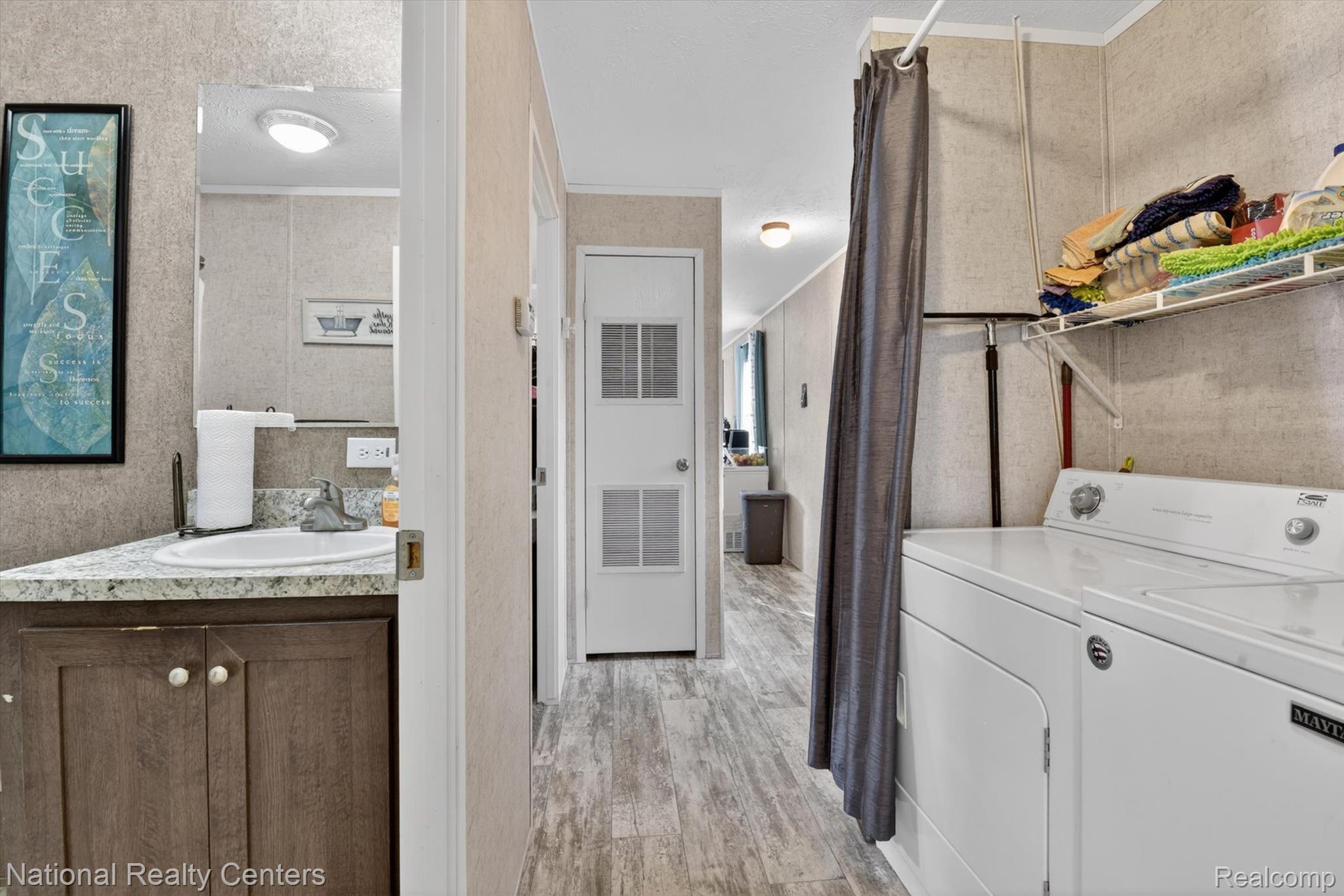2735 South Wagner Road, Unit 103 Ann Arbor, MI 48103 - Photo 14 of 20 Laundry area with light wood-style floors, washer and dryer, and ornamental molding