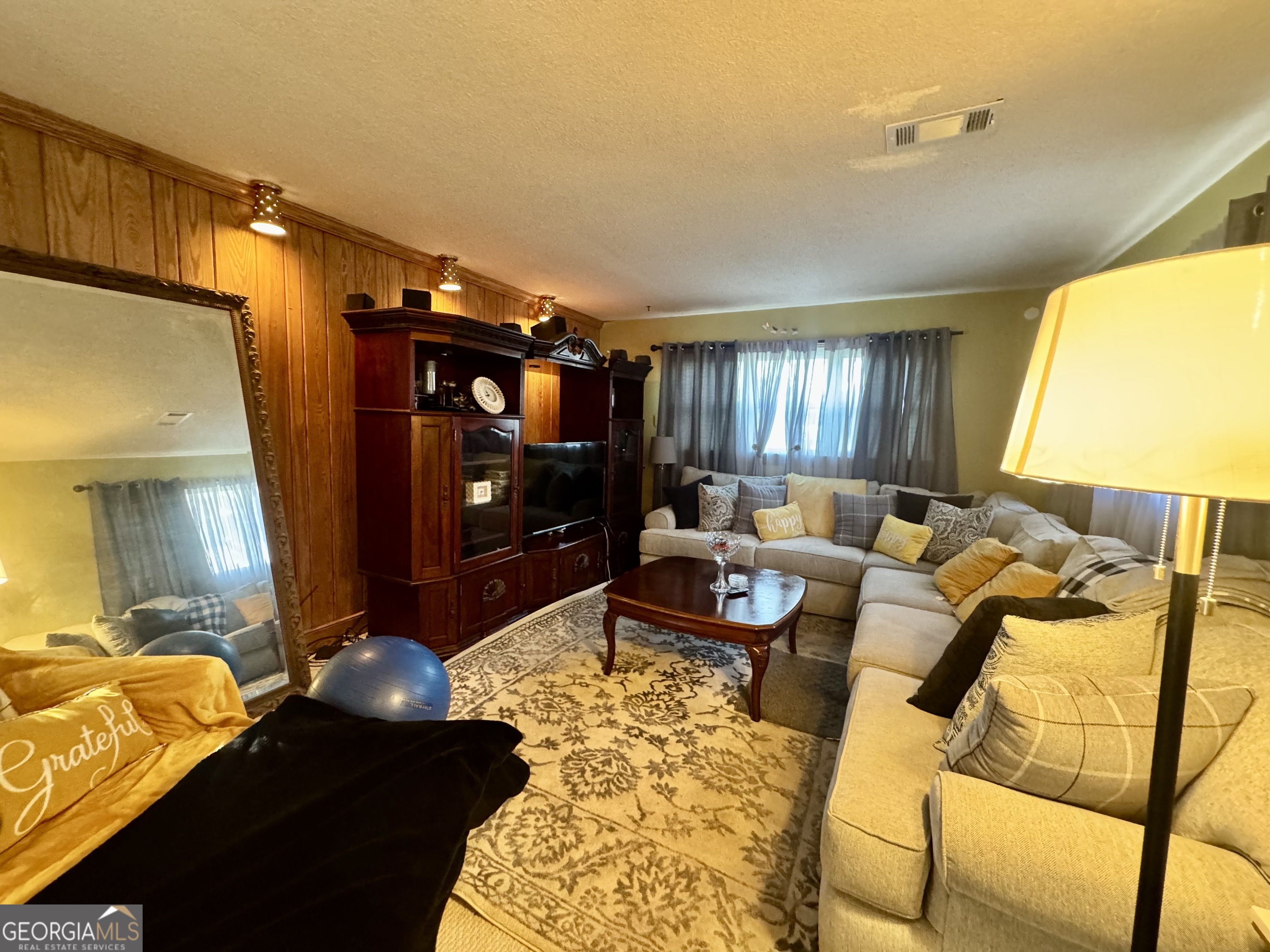914 Adderton Street Americus, GA 31719 - Photo 15 of 54 a living room with furniture and a flat screen tv
