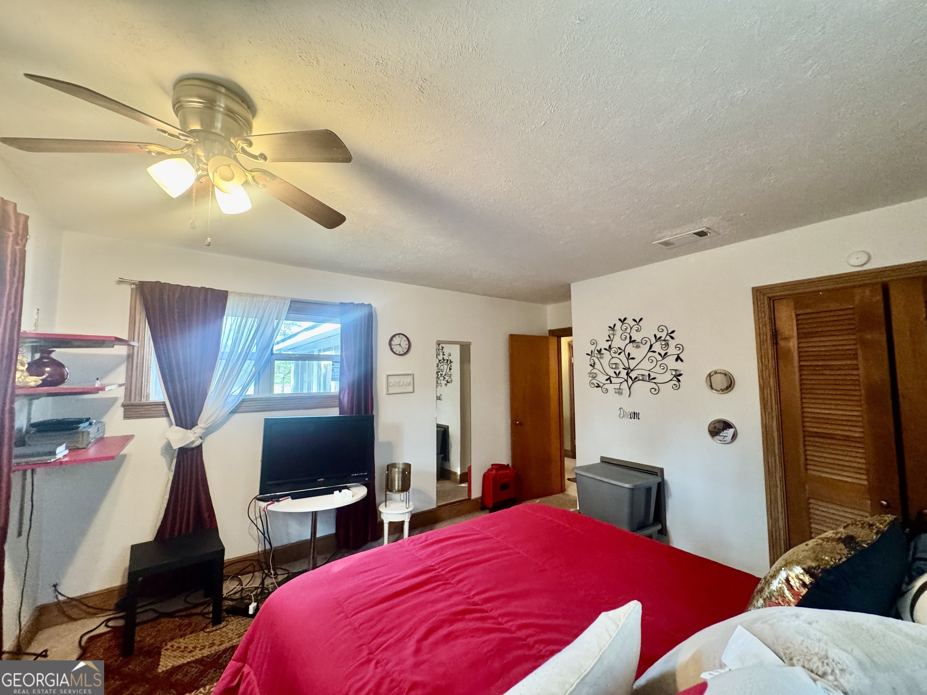 914 Adderton Street Americus, GA 31719 - Photo 29 of 54 a bedroom with a bed and flat screen tv