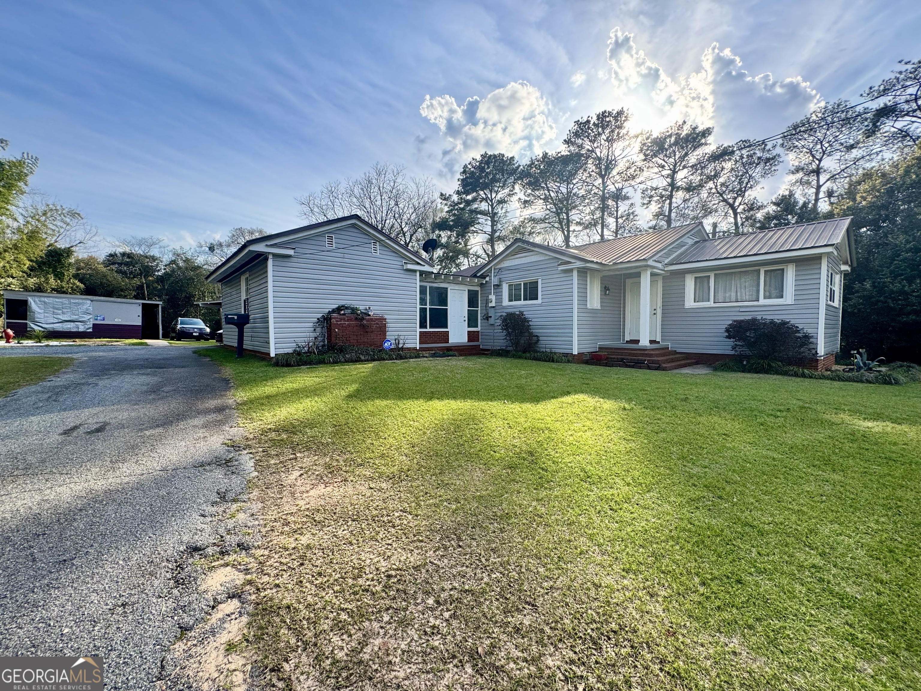 914 Adderton Street Americus, GA 31719 - Photo 3 of 54 a view of a house with a yard and pathway