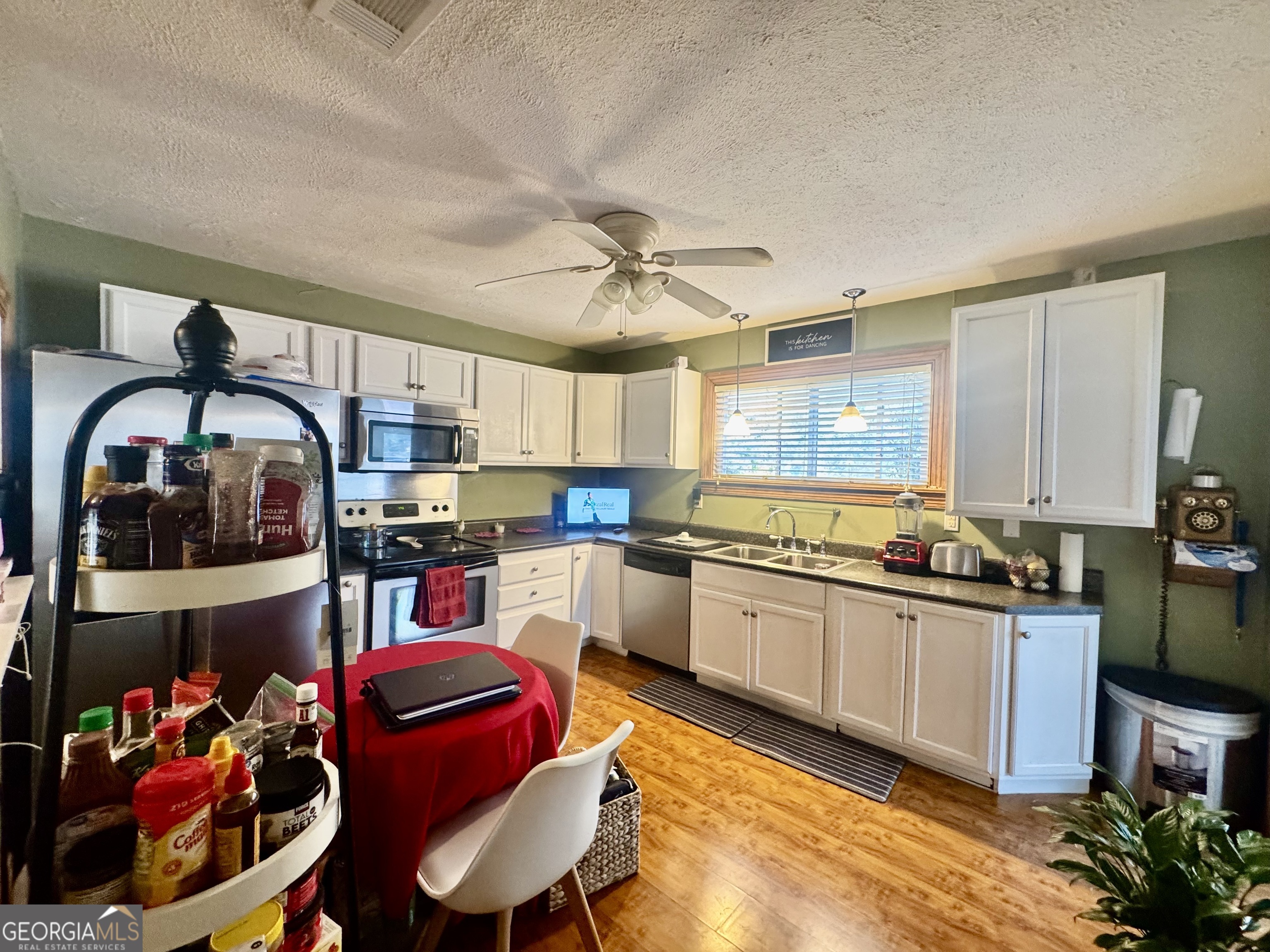 914 Adderton Street Americus, GA 31719 - Photo 36 of 54 a kitchen with stainless steel appliances granite countertop a stove and a sink