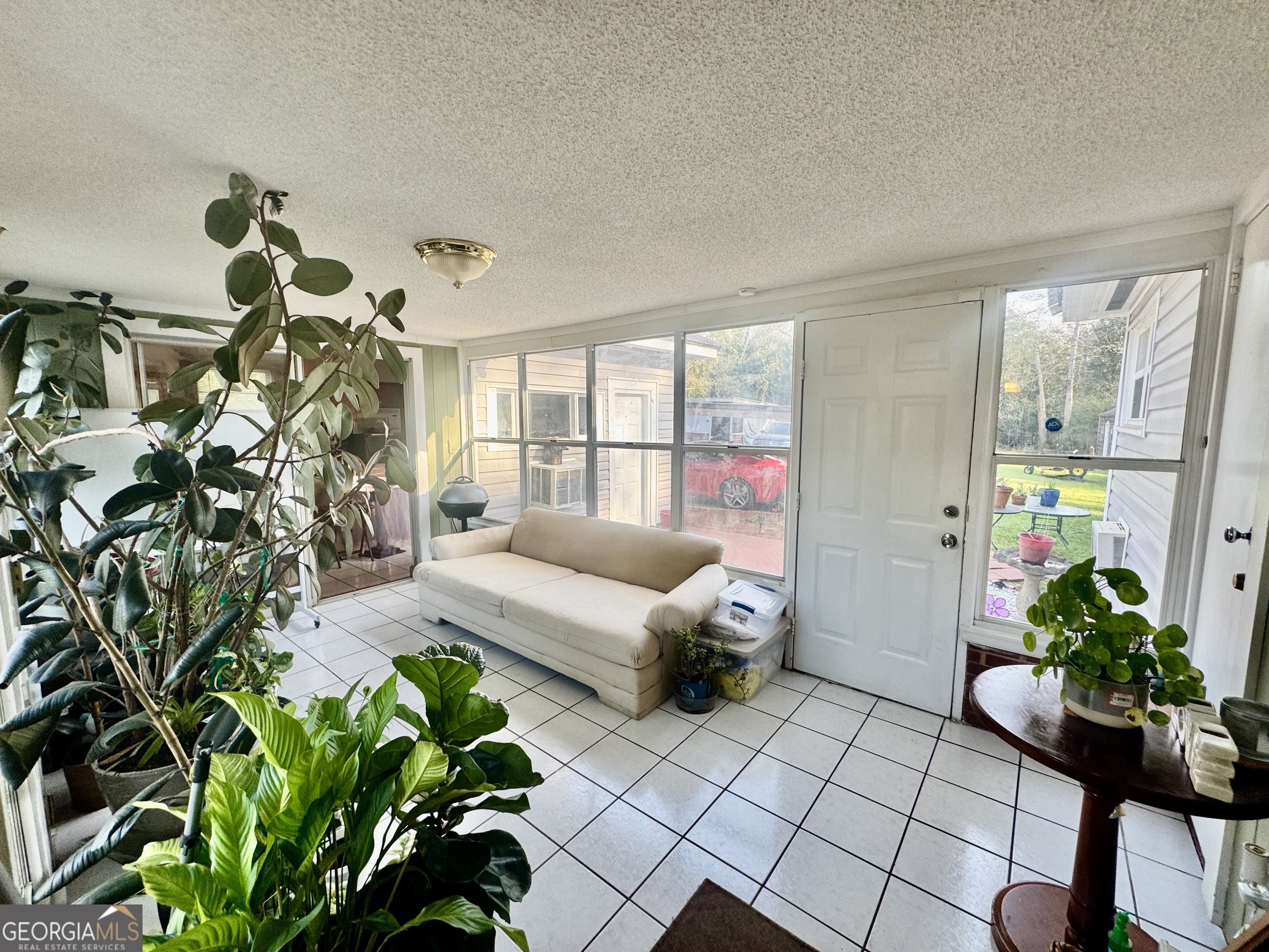 914 Adderton Street Americus, GA 31719 - Photo 37 of 54 a living room with furniture flowers and a potted plant