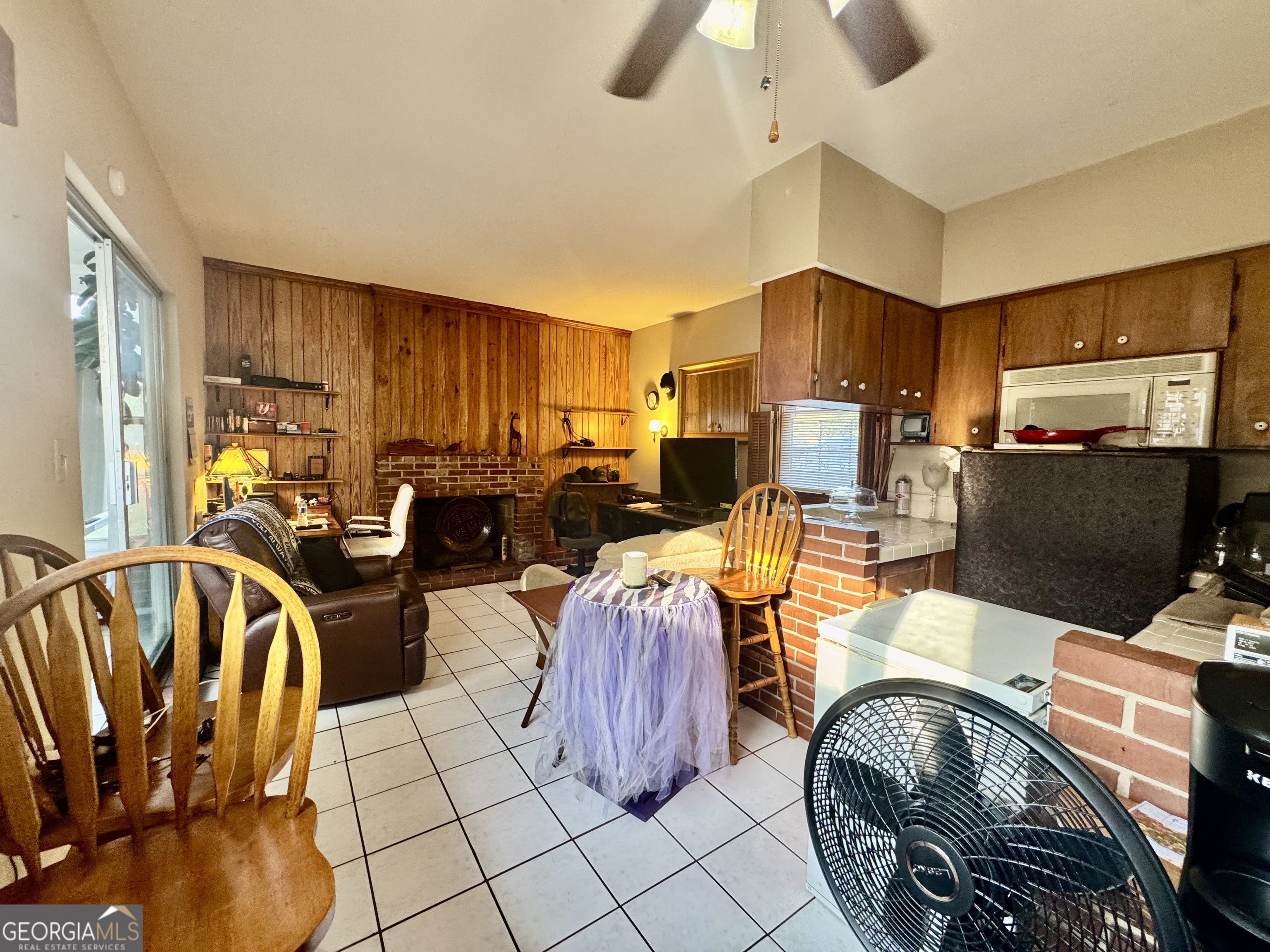 914 Adderton Street Americus, GA 31719 - Photo 44 of 54 a living room with furniture a flat screen tv and kitchen view