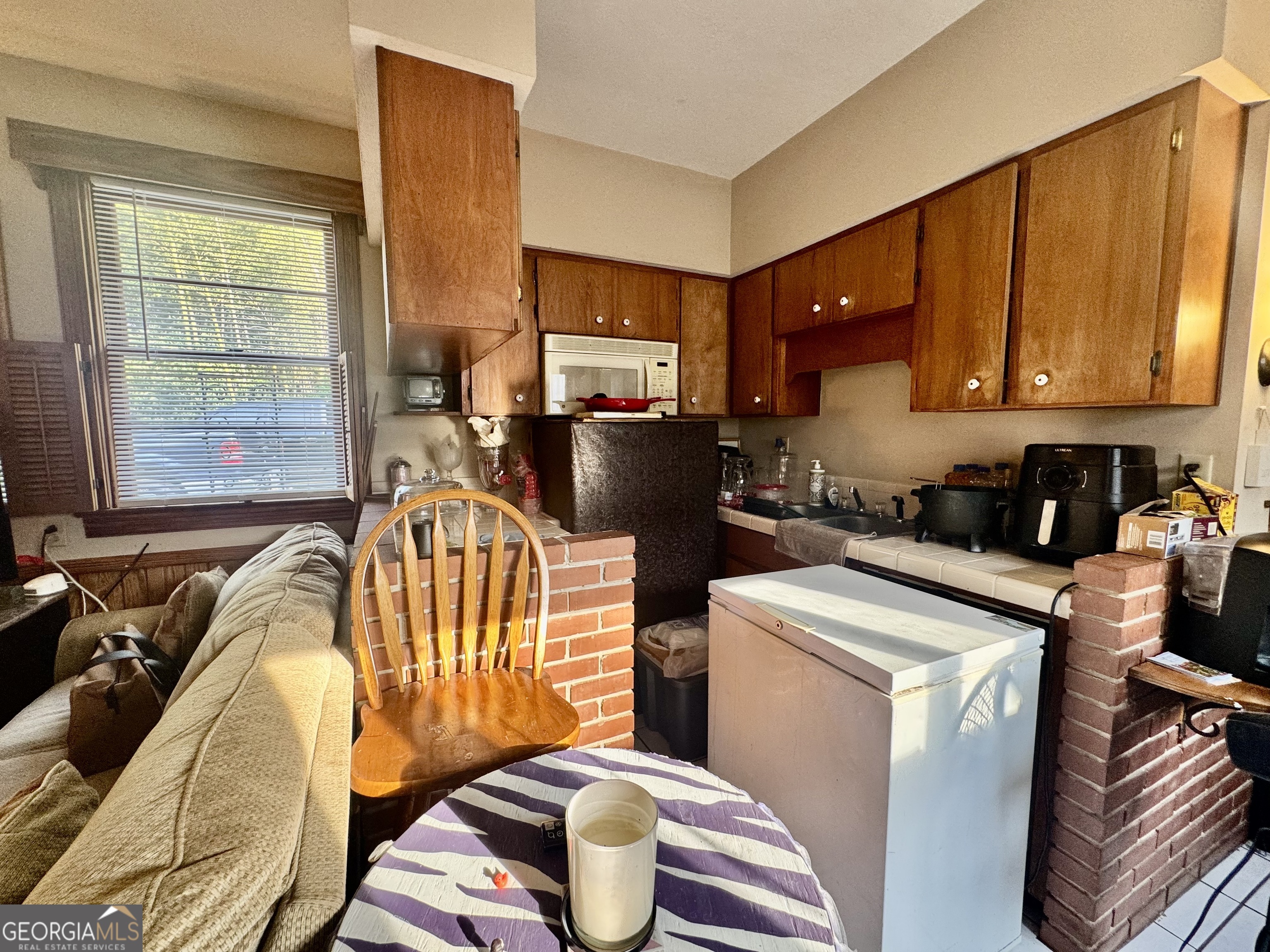 914 Adderton Street Americus, GA 31719 - Photo 46 of 54 a kitchen with a refrigerator and a stove top oven