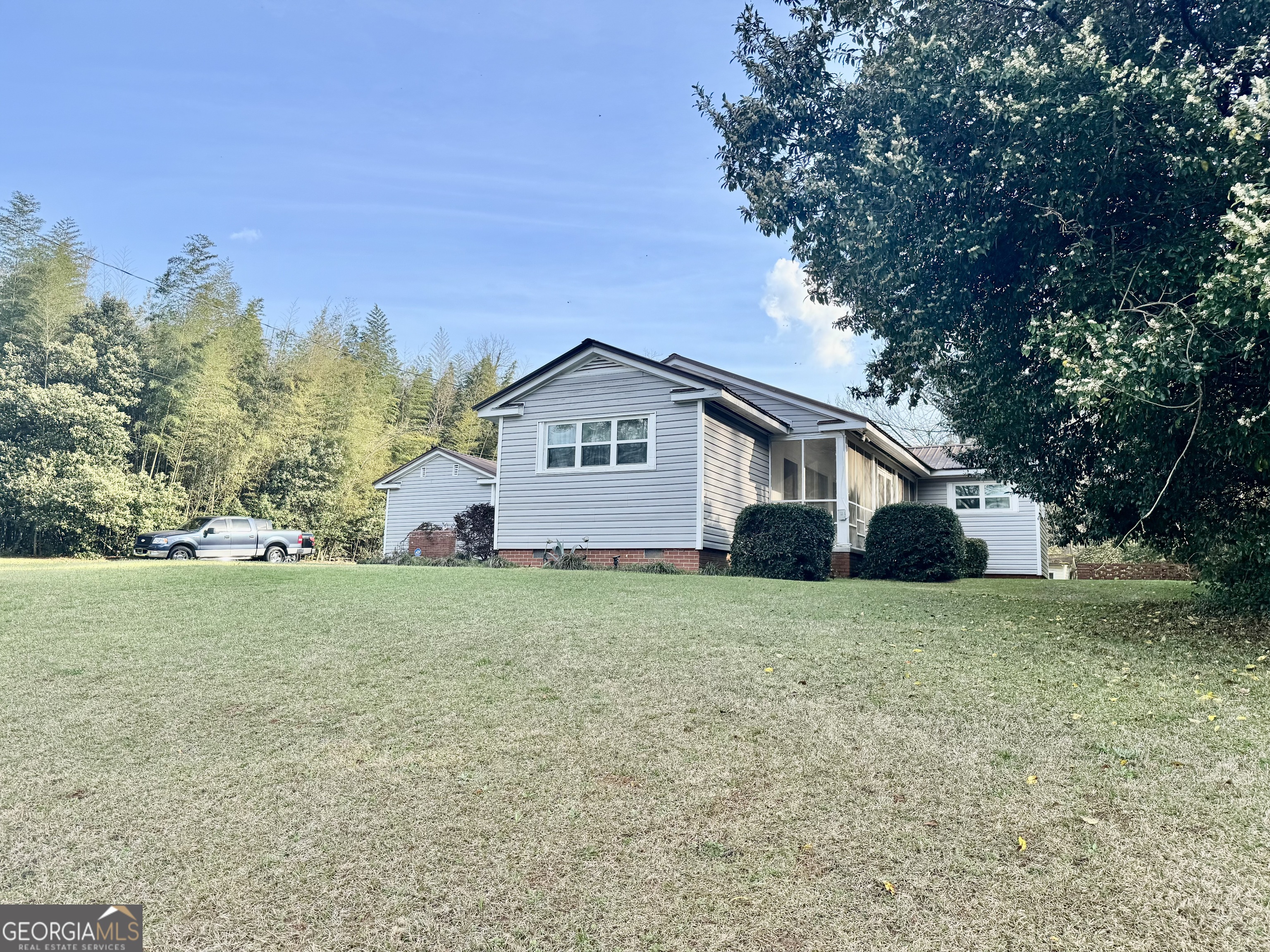 914 Adderton Street Americus, GA 31719 - Photo 6 of 54 a house with huge green field in front of it
