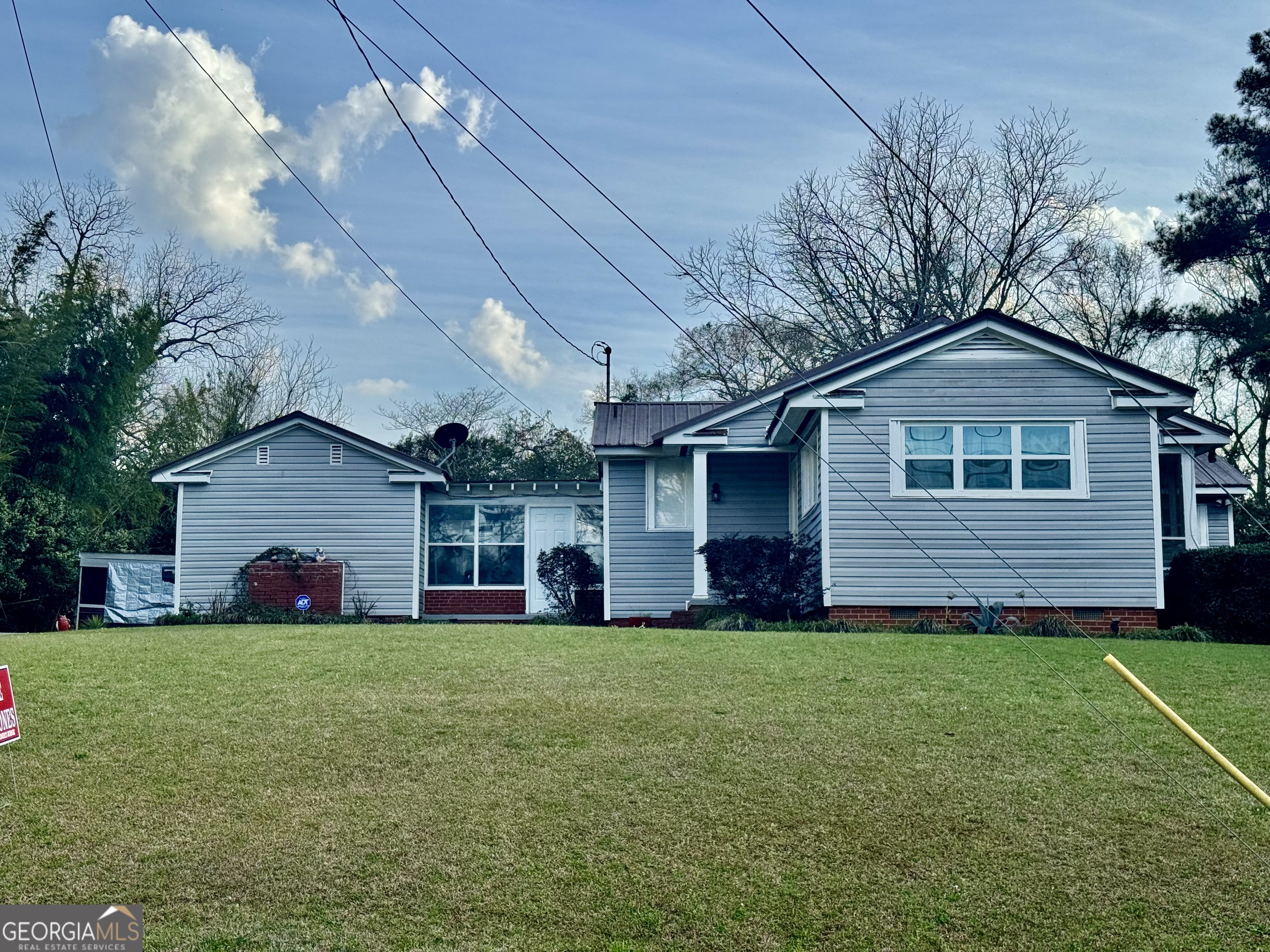914 Adderton Street Americus, GA 31719 - Photo 7 of 54 a front view of a house with a yard and garage
