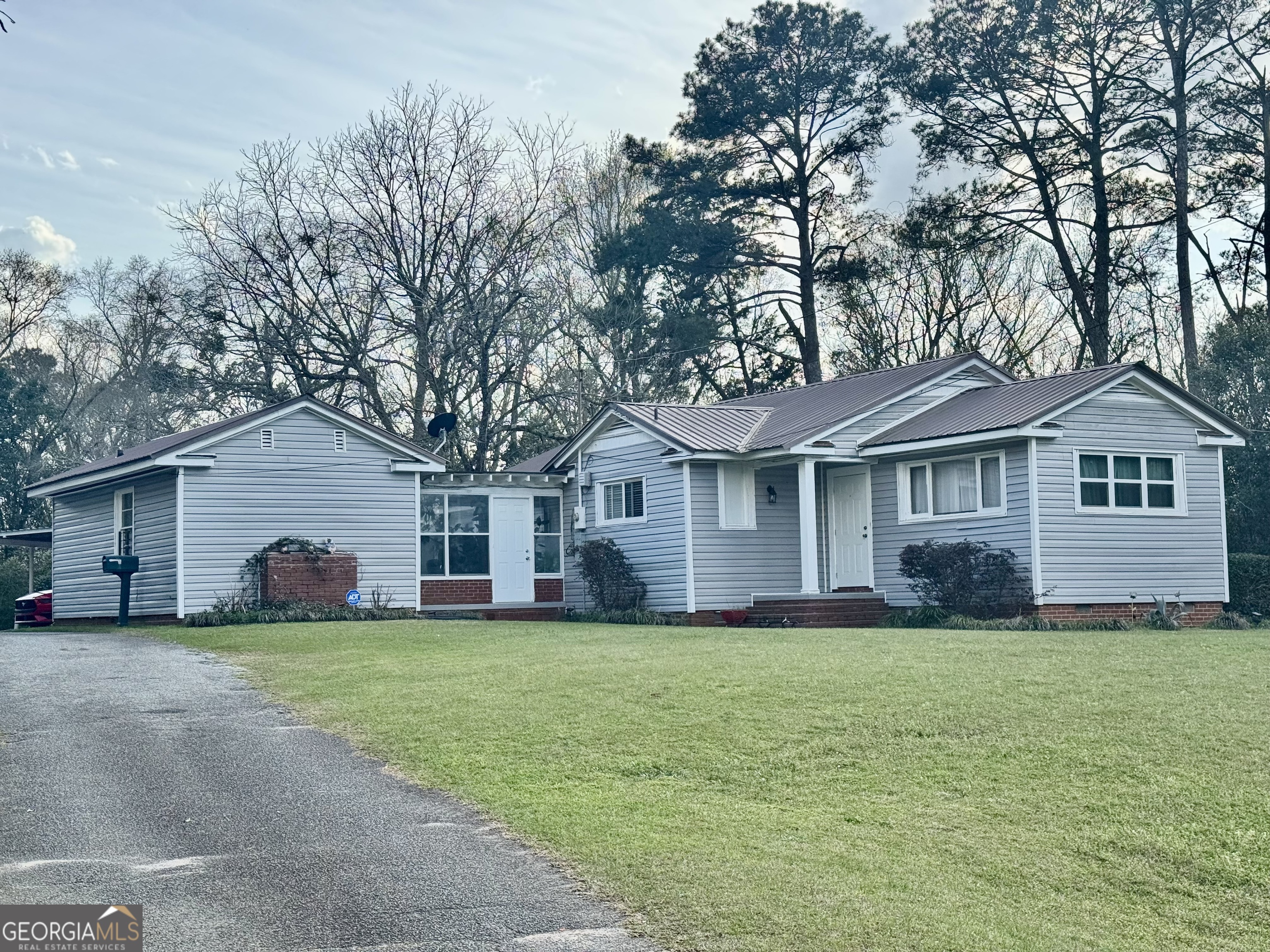 914 Adderton Street Americus, GA 31719 - Photo 8 of 54 a front view of a house with a yard and trees