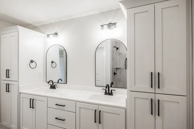 a bathroom with a double vanity sink and mirror