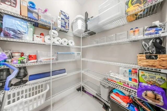 a large kitchen with stainless steel appliances granite countertop a sink a stove and a wooden floors