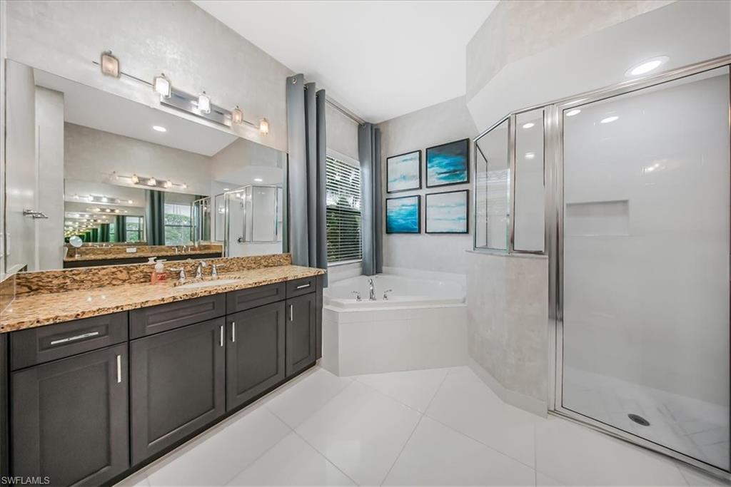 4036 Nova Lane Naples, FL 34119 - Photo 20 of 50 a bathroom with a granite countertop tub sink shower and mirror