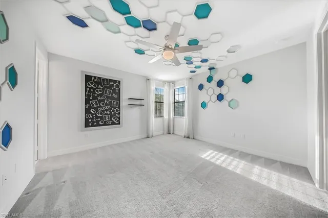 an empty room with closet and windows