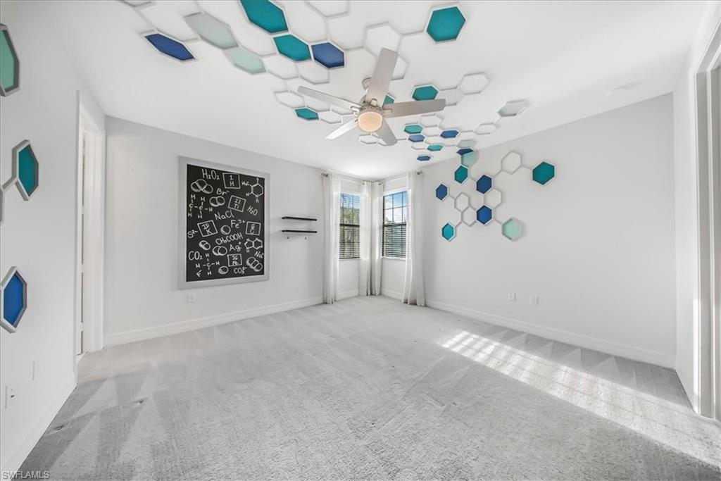 4036 Nova Lane Naples, FL 34119 - Photo 30 of 50 en empty room with window and ceiling fan