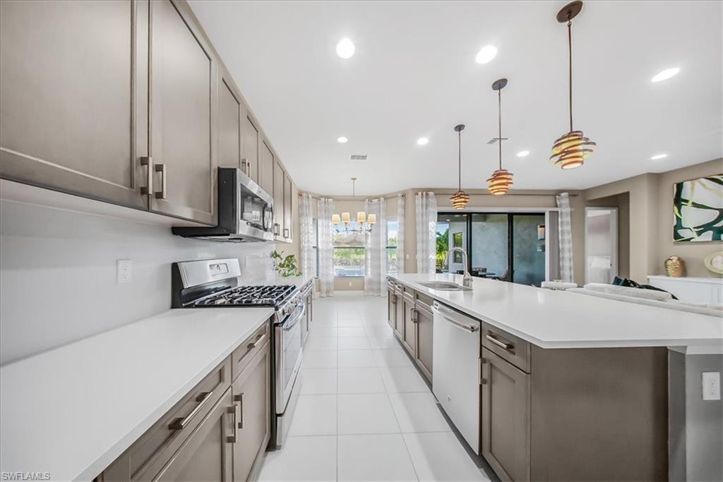 4036 Nova Lane Naples, FL 34119 - Photo 6 of 50 a large kitchen with stainless steel appliances granite countertop a sink a stove and a wooden floors