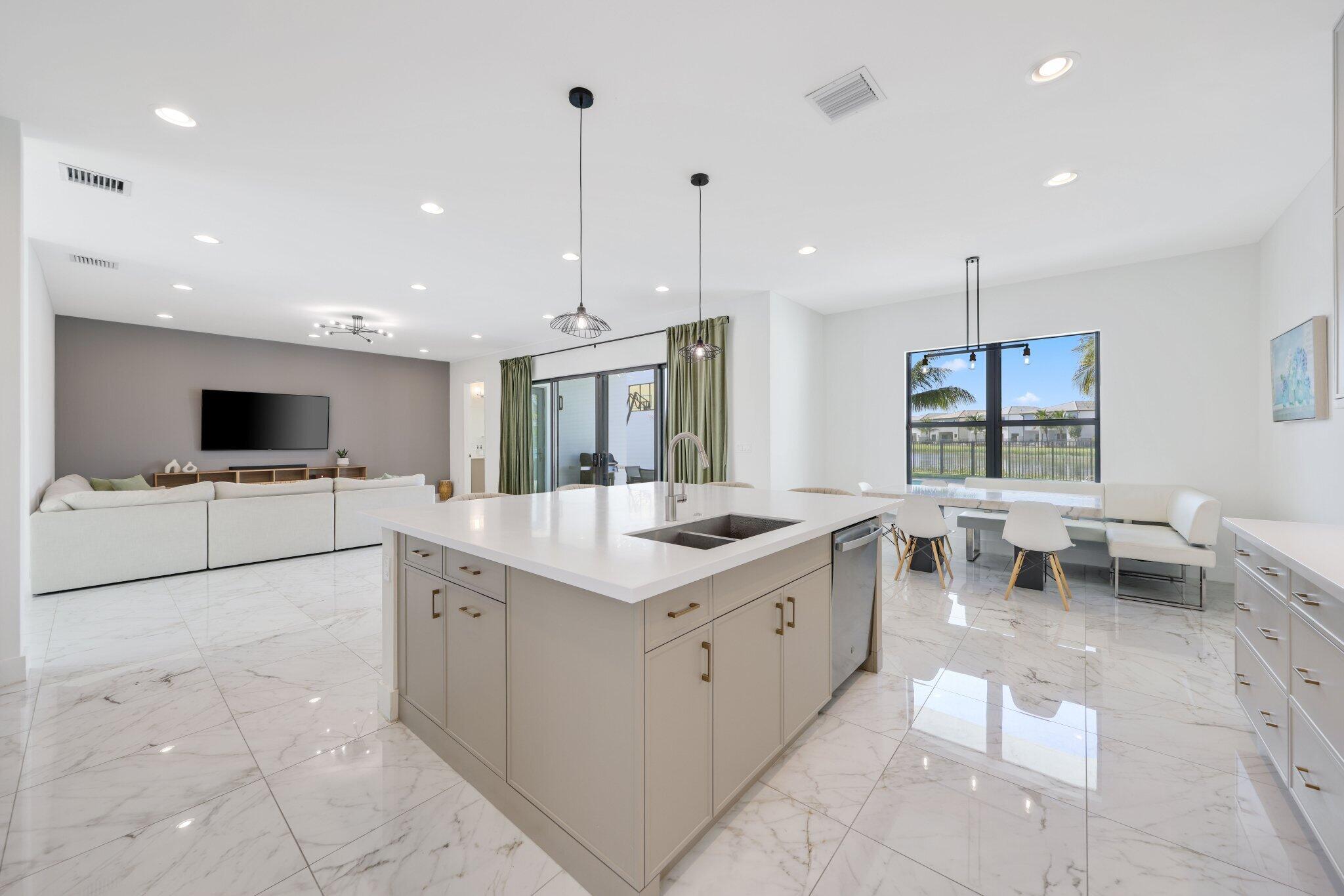8116 Laurel Falls Drive Boca Raton, FL 33496 - Photo 17 of 81 a kitchen with stainless steel appliances kitchen island granite countertop a sink and a stove