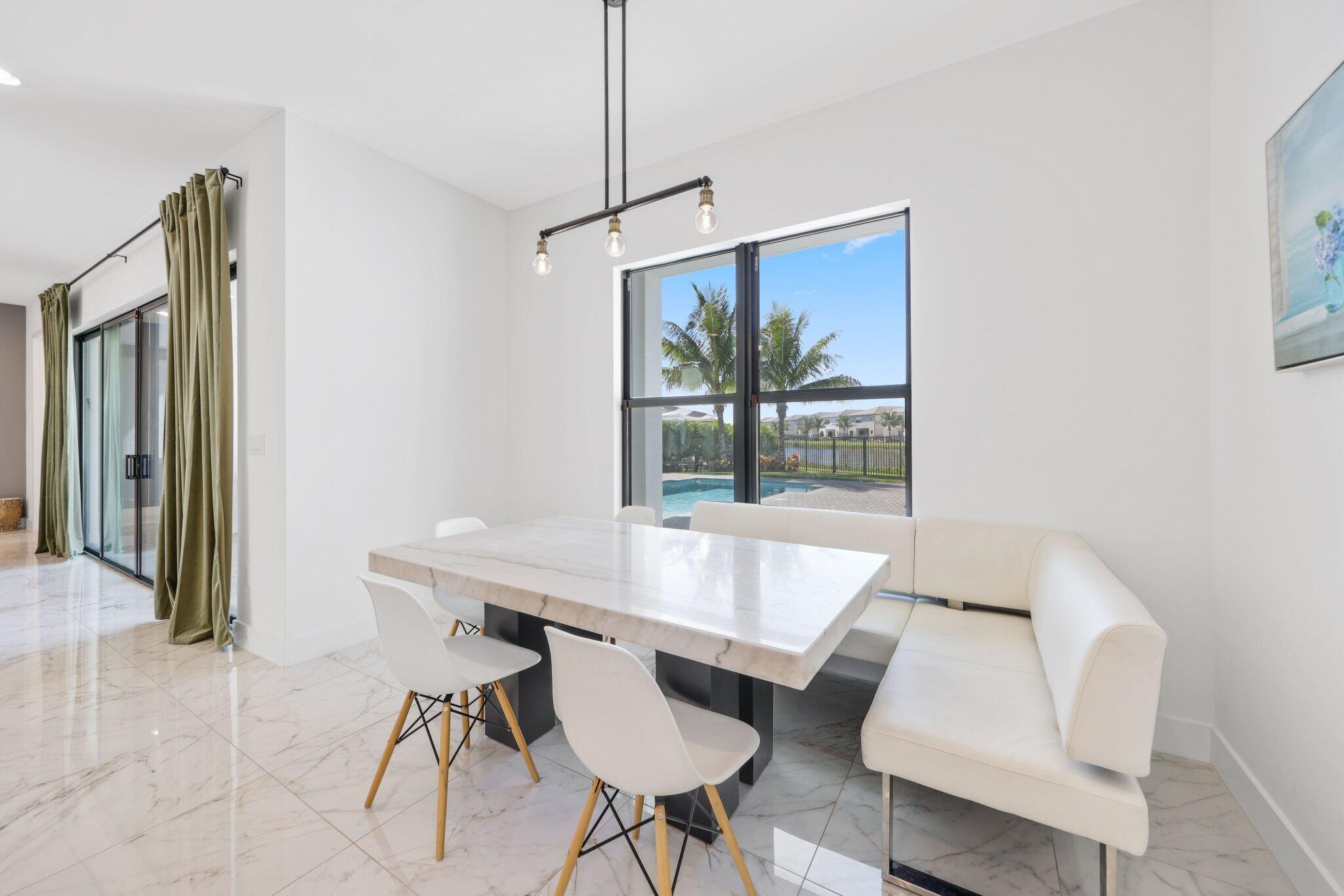 8116 Laurel Falls Drive Boca Raton, FL 33496 - Photo 22 of 81 a view of a dining room with furniture window and outside view