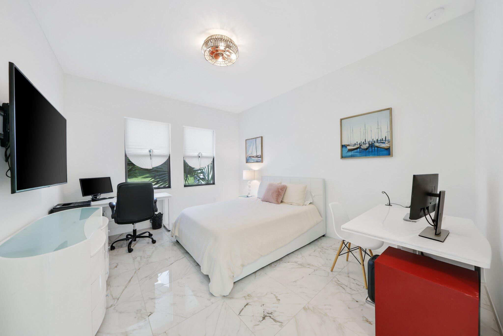8116 Laurel Falls Drive Boca Raton, FL 33496 - Photo 24 of 81 a bedroom with a bed a computer on the desk and a couch