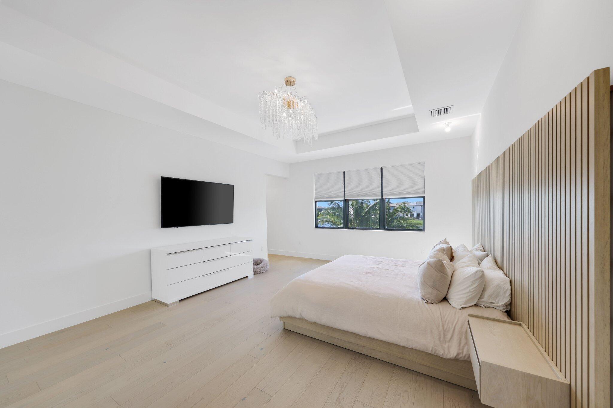 8116 Laurel Falls Drive Boca Raton, FL 33496 - Photo 28 of 81 a spacious bedroom with a bed and a flat screen tv