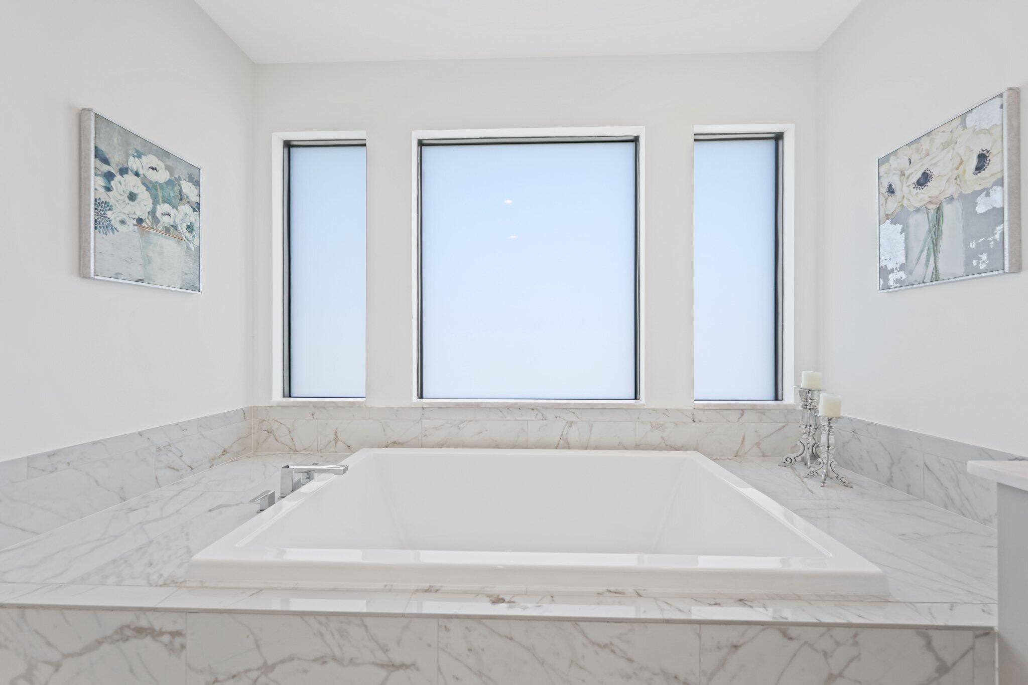 8116 Laurel Falls Drive Boca Raton, FL 33496 - Photo 32 of 81 a bathroom with bathtub and next to a window