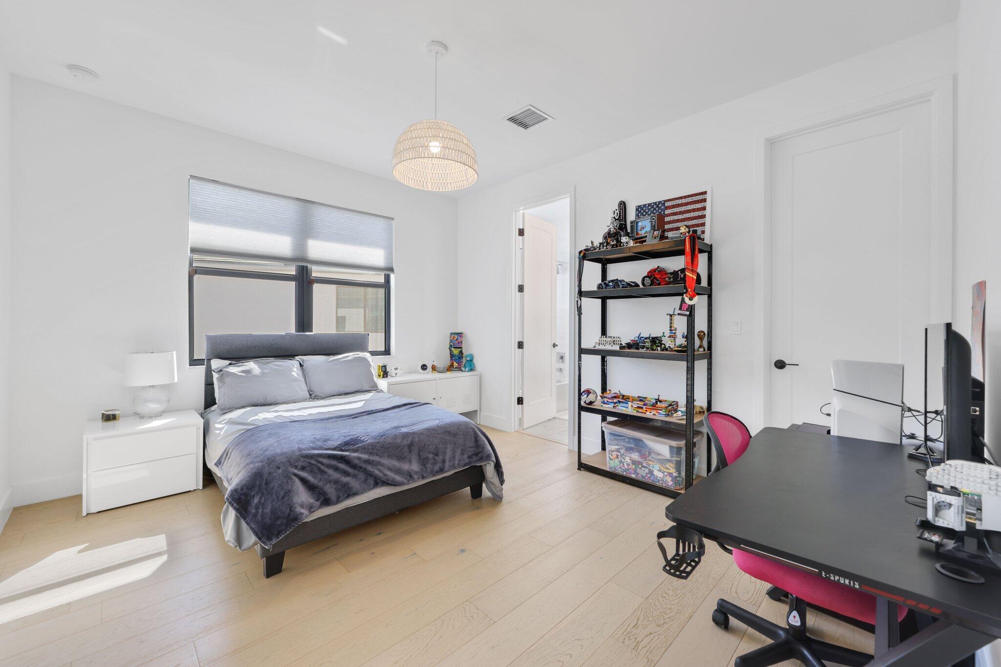 8116 Laurel Falls Drive Boca Raton, FL 33496 - Photo 35 of 81 a bedroom with furniture and a flat screen tv