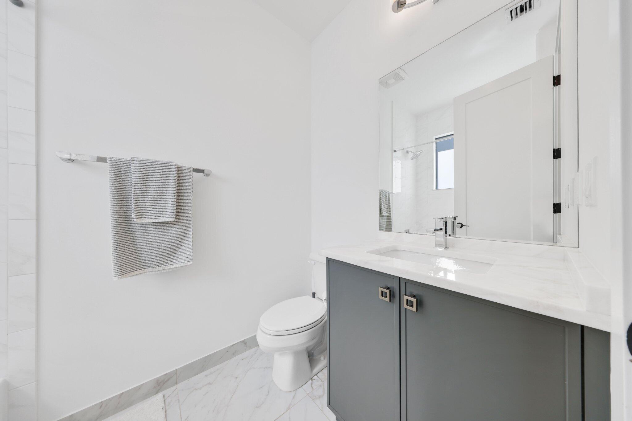 8116 Laurel Falls Drive Boca Raton, FL 33496 - Photo 36 of 81 a bathroom with a toilet a sink and mirror