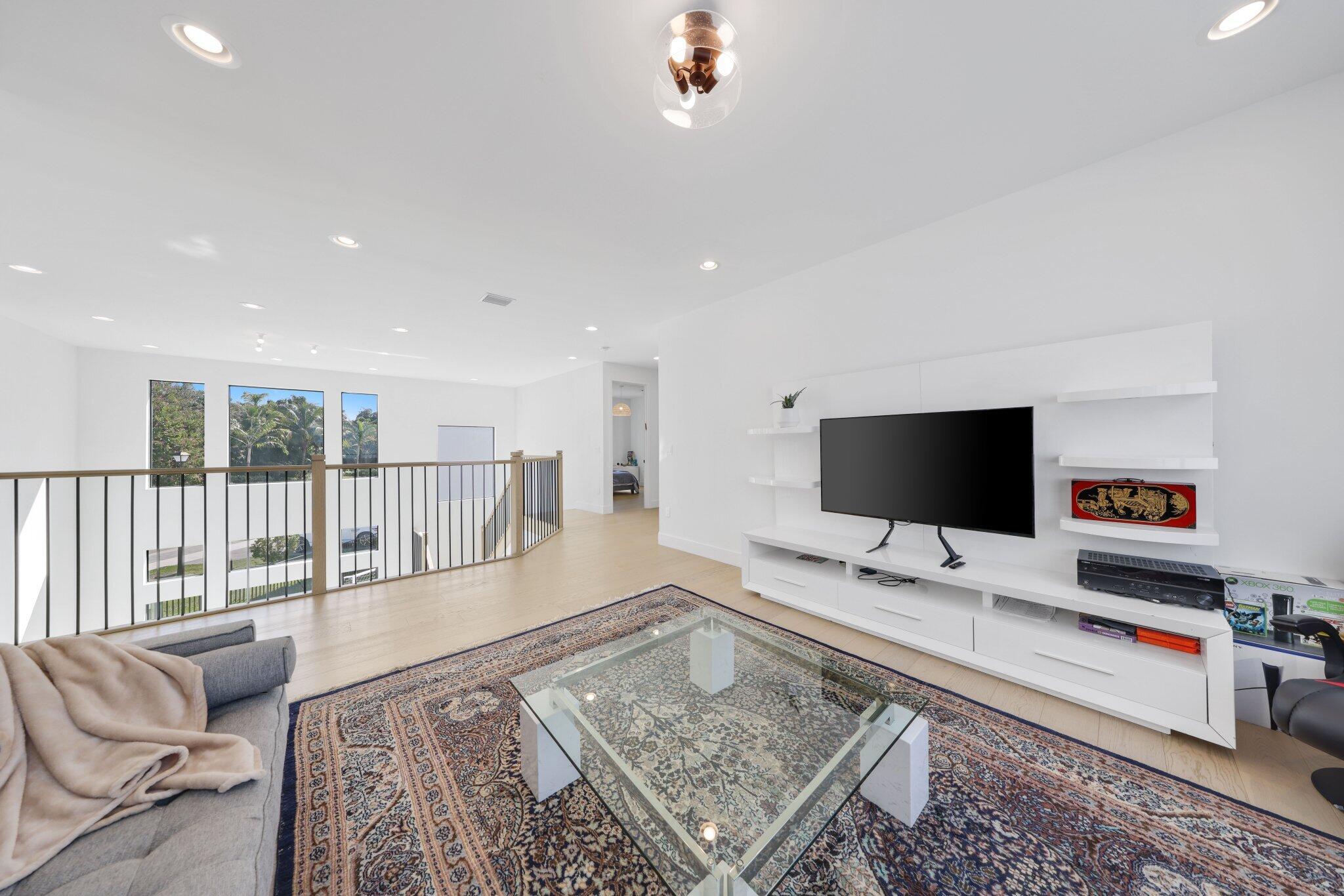 8116 Laurel Falls Drive Boca Raton, FL 33496 - Photo 39 of 81 a living room with furniture and a flat screen tv