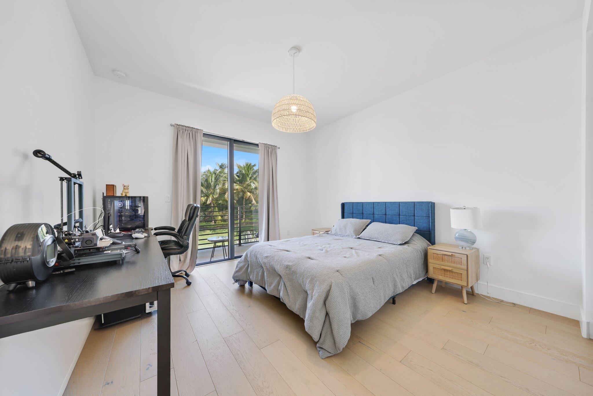 8116 Laurel Falls Drive Boca Raton, FL 33496 - Photo 44 of 81 a bedroom with a bed and a chandelier