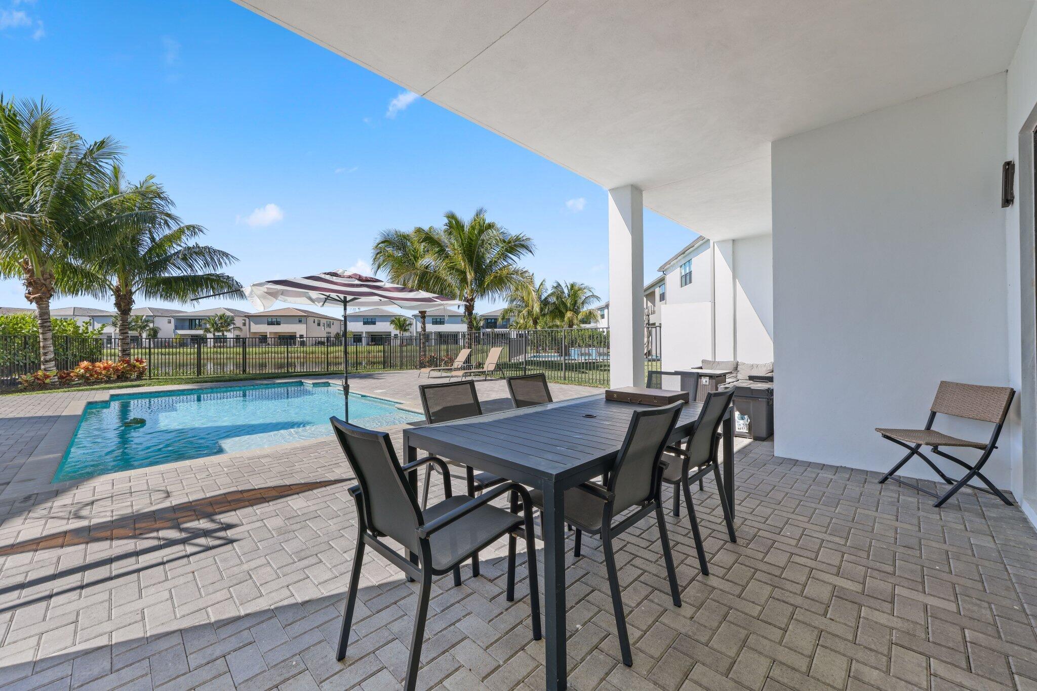8116 Laurel Falls Drive Boca Raton, FL 33496 - Photo 48 of 81 a patio with a table and chairs and potted plants
