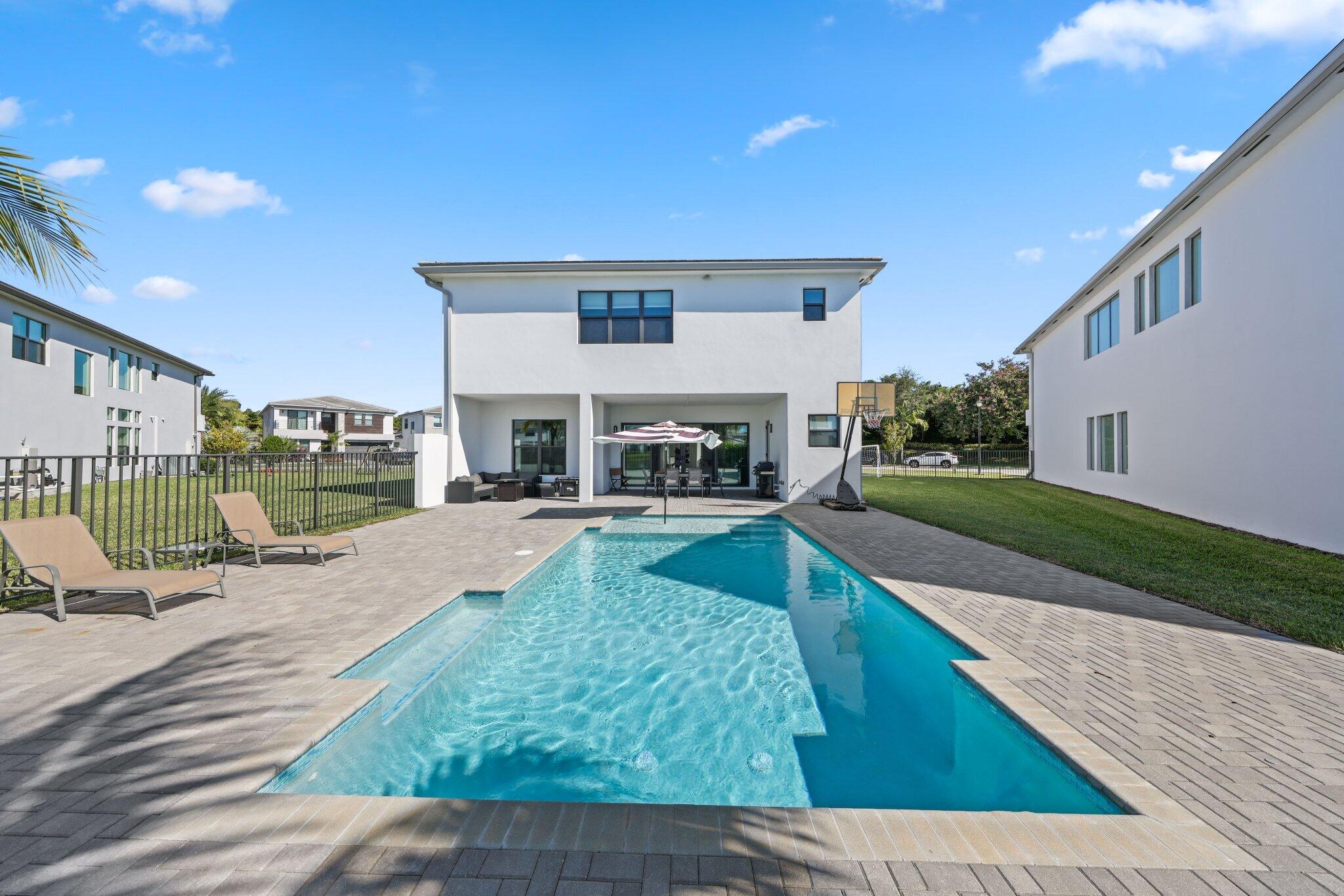 8116 Laurel Falls Drive Boca Raton, FL 33496 - Photo 54 of 81 a view of a house with swimming pool and sitting area