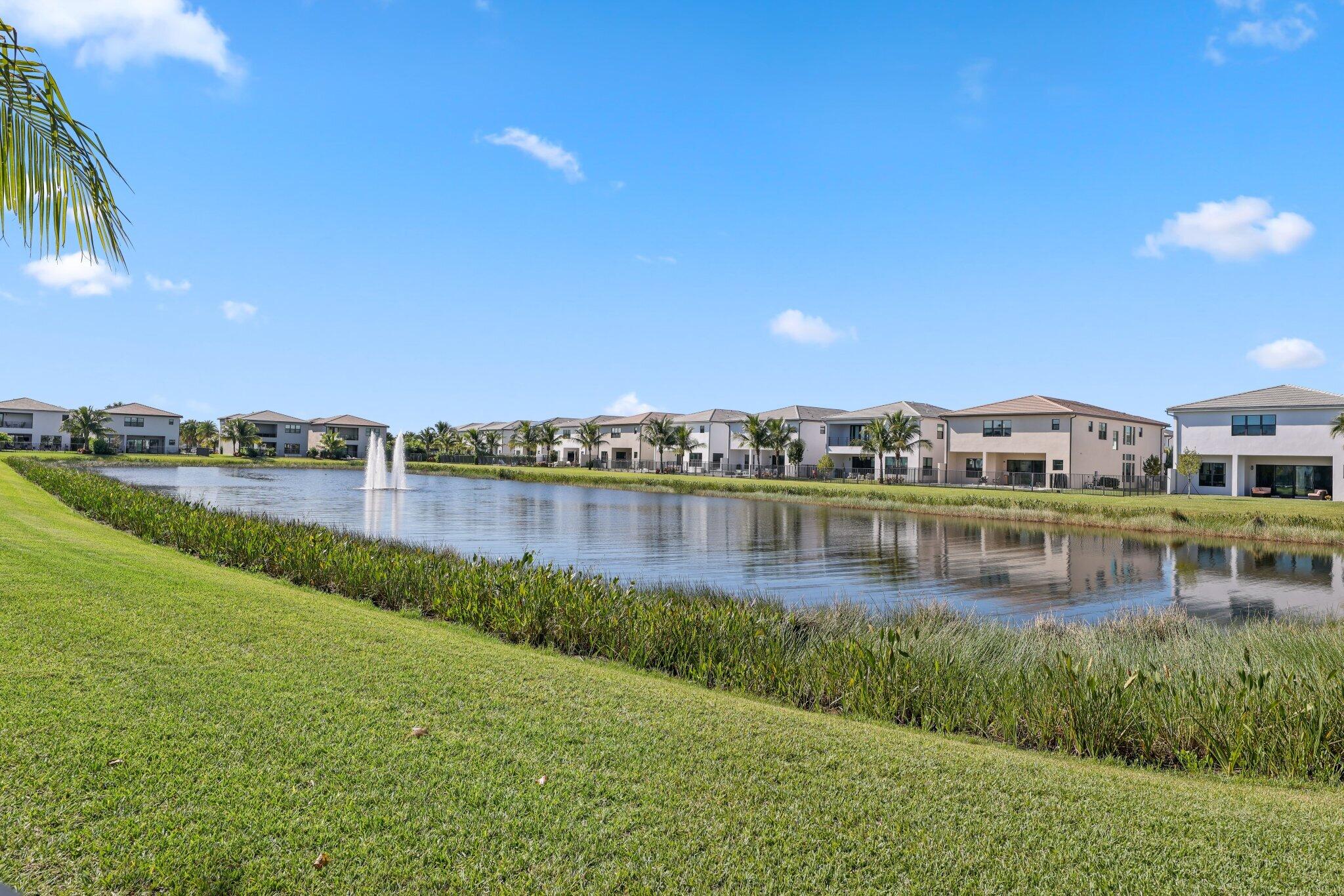 8116 Laurel Falls Drive Boca Raton, FL 33496 - Photo 56 of 81 a view of a lake with houses in the background