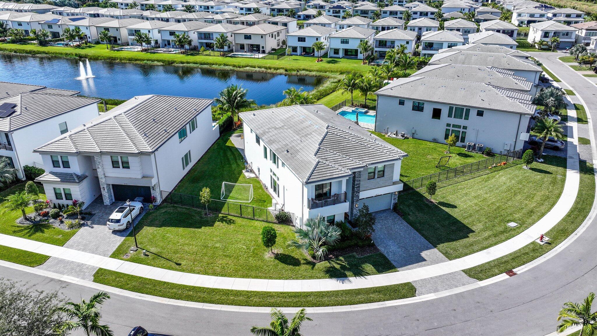 8116 Laurel Falls Drive Boca Raton, FL 33496 - Photo 57 of 81 an aerial view of a house with a garden and lake view