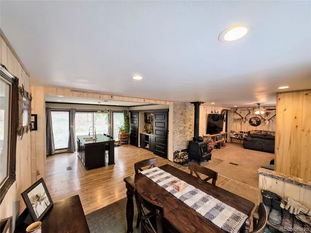 a living room with furniture a couch and large windows