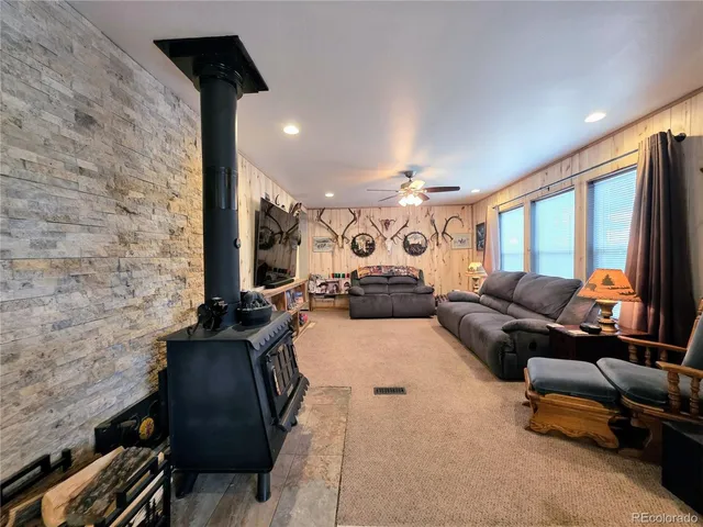 a living room with furniture gym equipment and a large window