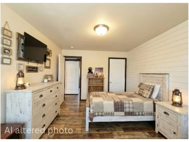 a en suite bathroom with a granite countertop sink and a mirror