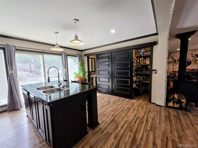 a dining hall with stainless steel appliances granite countertop a stove and a kitchen island