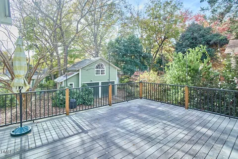 a view of a deck with a large window and wooden floor