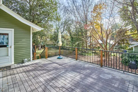 a view of a backyard with a large tree