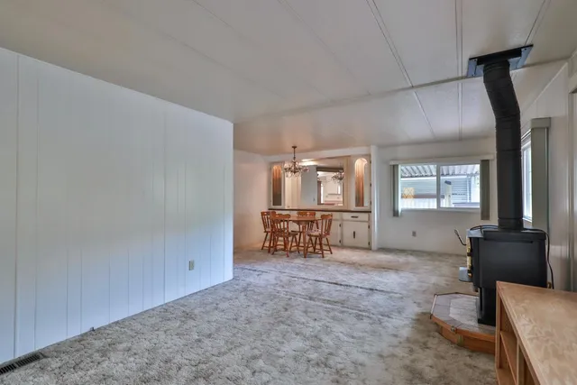 a view of a dining room with furniture and chandelier
