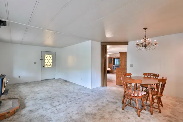 a room with lots of chairs and a chandelier
