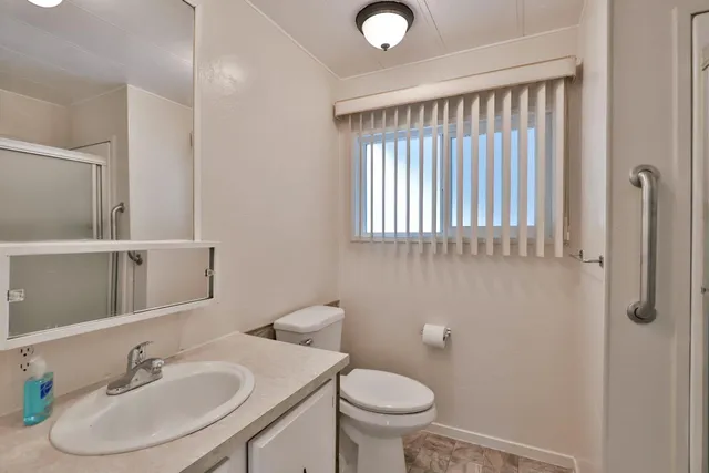 a bathroom with a glass shower door
