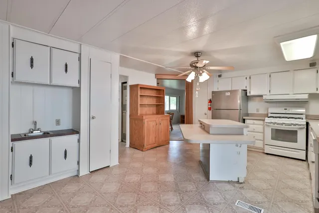 a kitchen with a sink stove and refrigerator